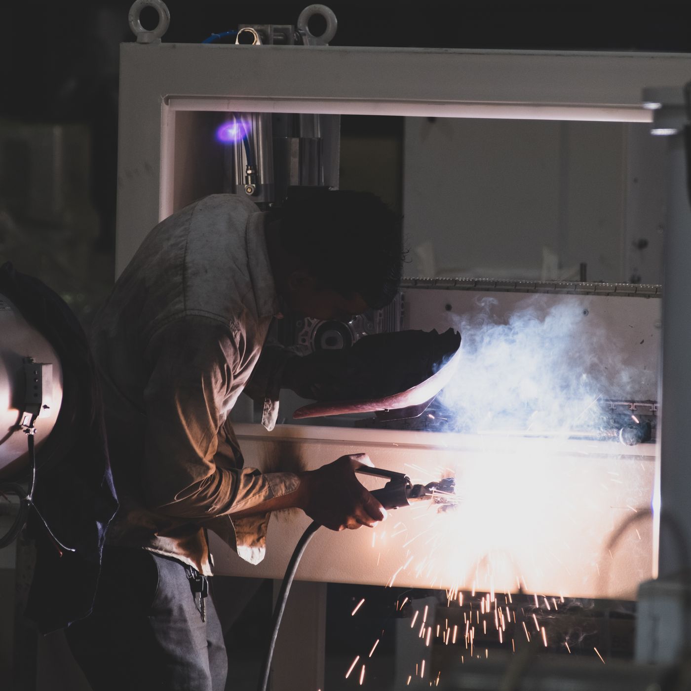 Welder at work with sparks flying in Mumbai