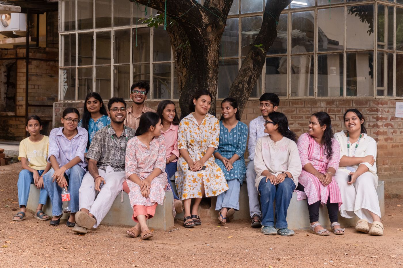 Group of young Indian students sitting together on campus