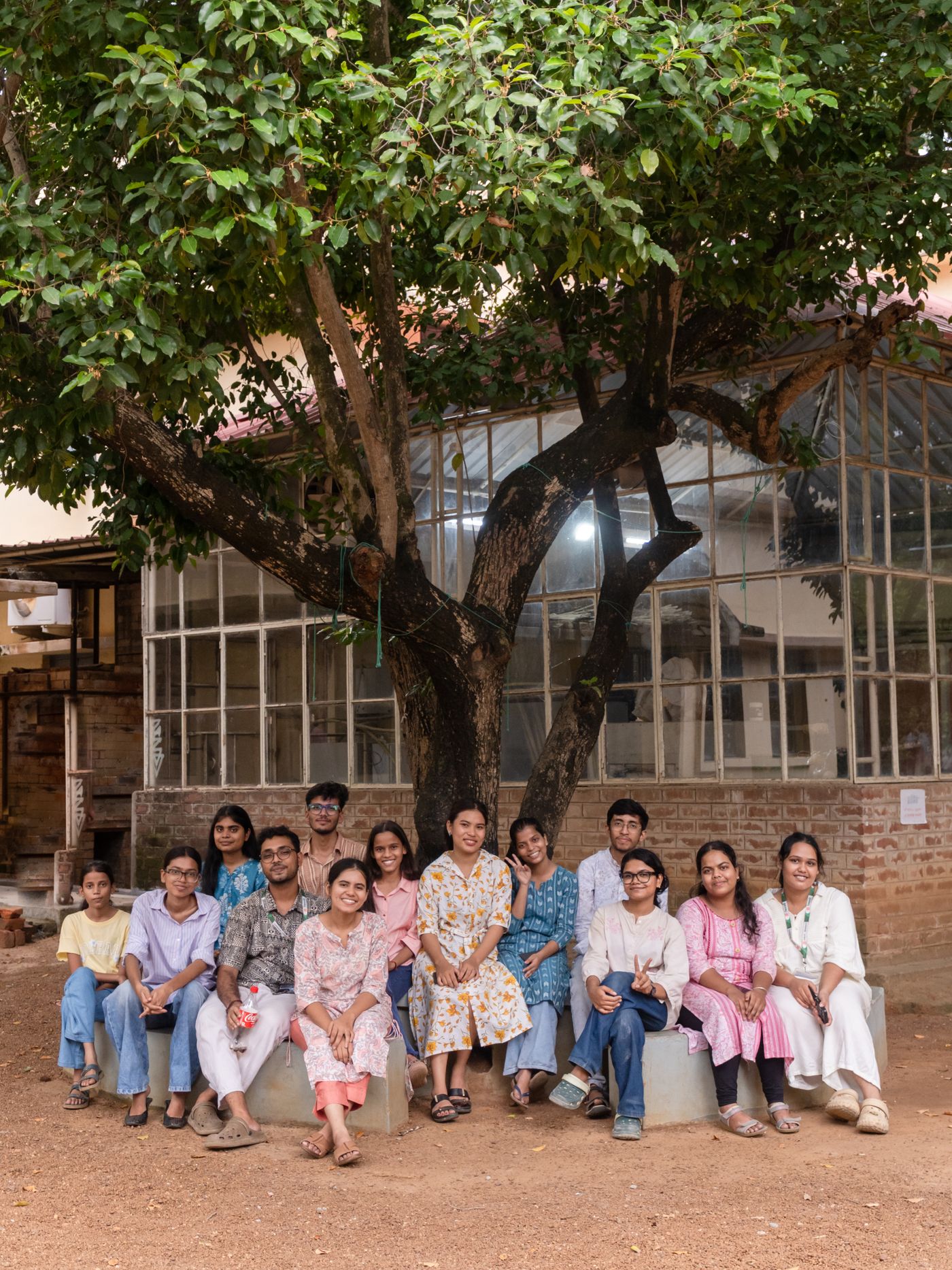 Group portrait of Indian college students under a tree