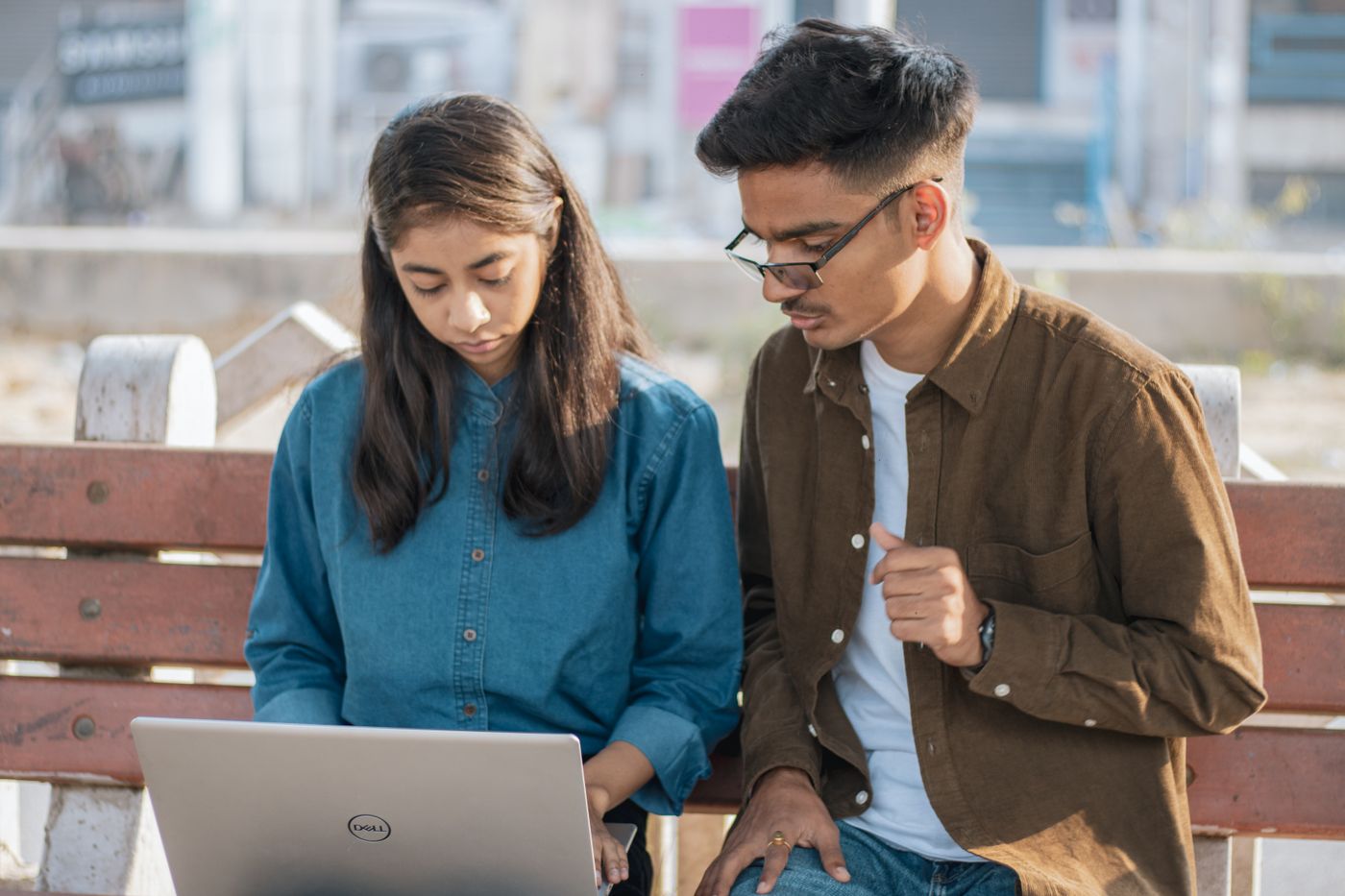 Two young Indians working together on a laptop